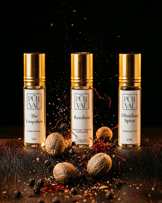 Three Purvae 6 ml parfum oils among tumbling nutmeg, saffron and black pepper on dark leather