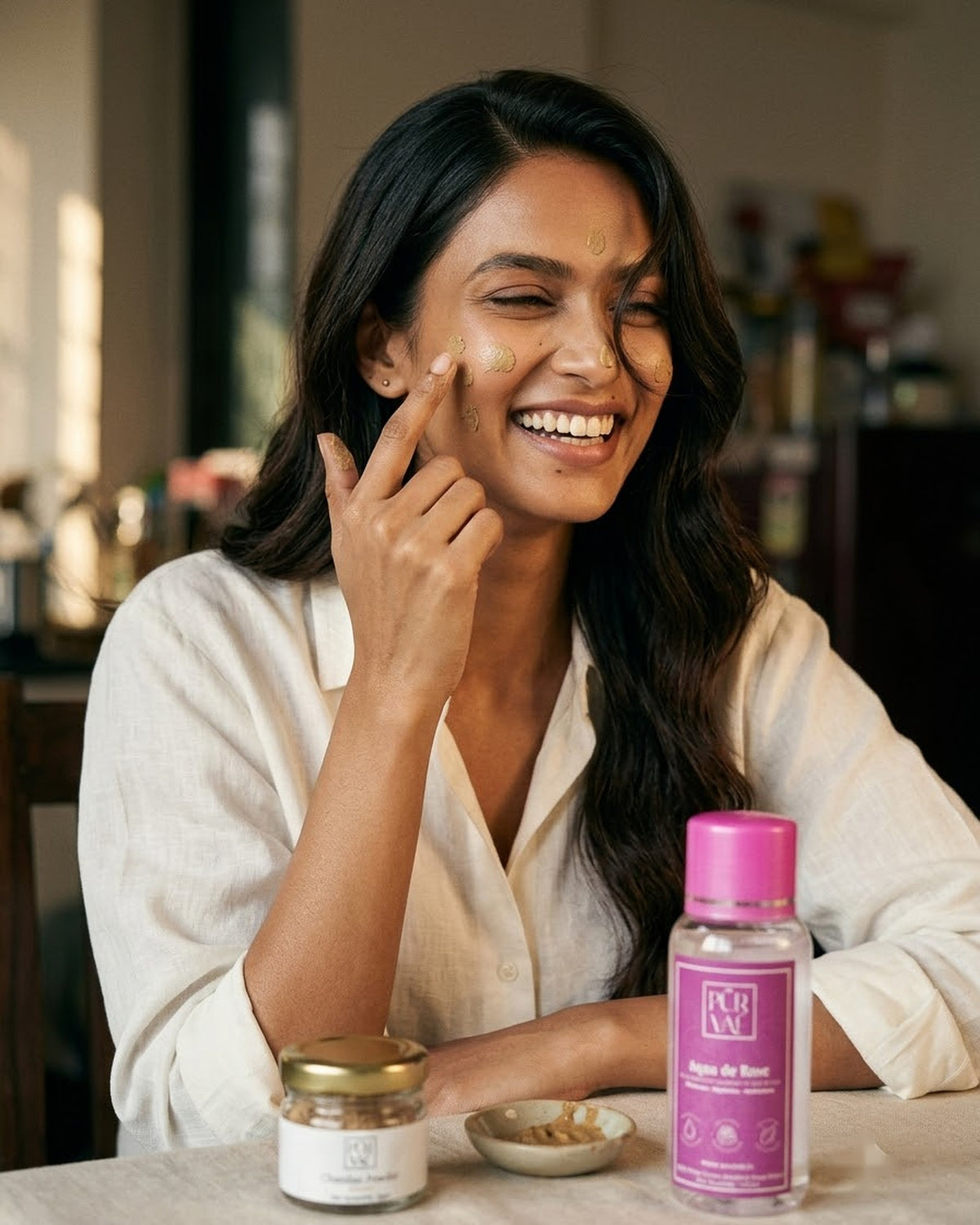 Woman applying chandan paste to her face