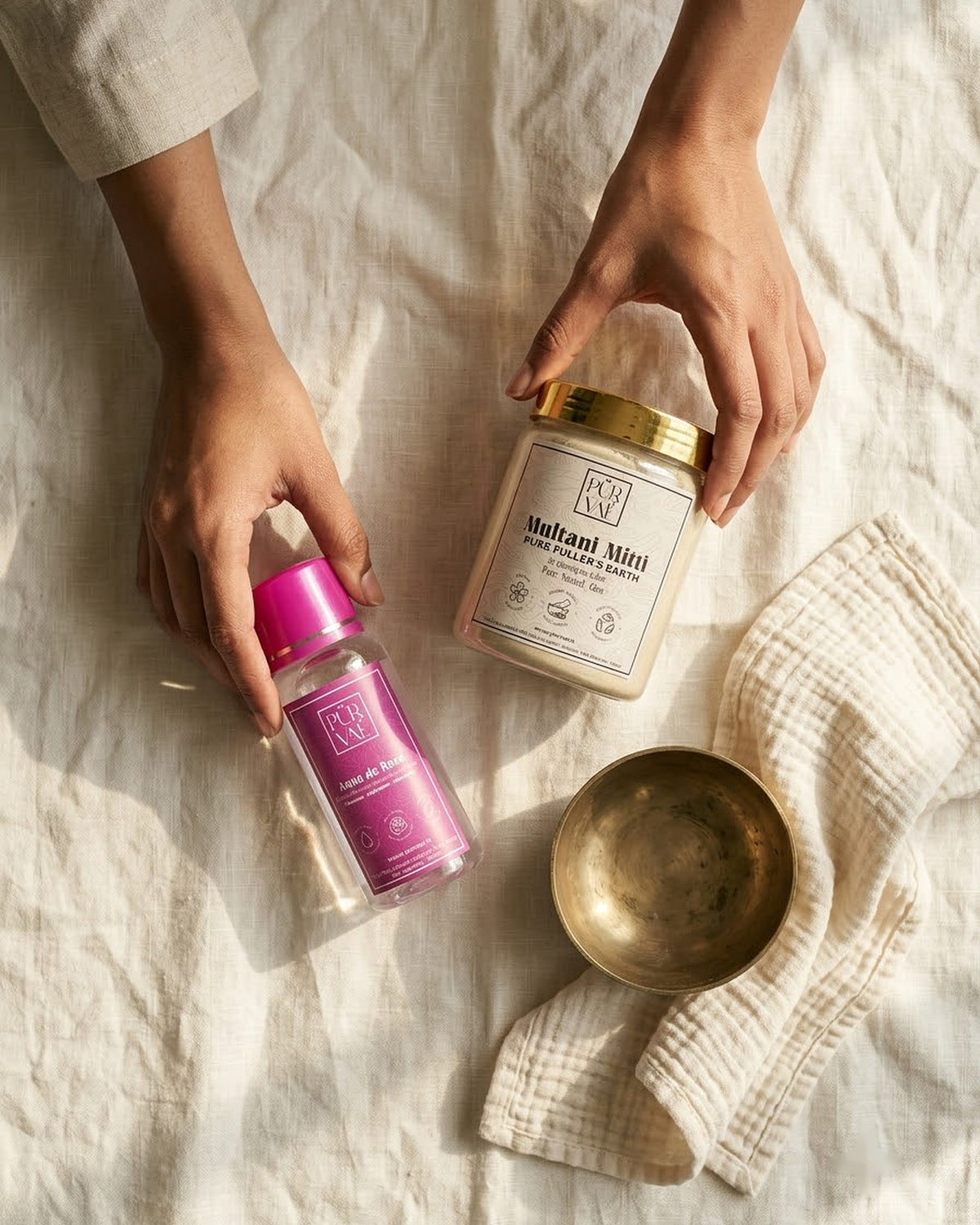 Hands arranging the Purvae Mitti Ritual products
