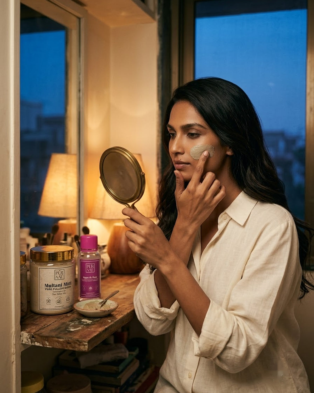 Woman applying Multani mitti face pack