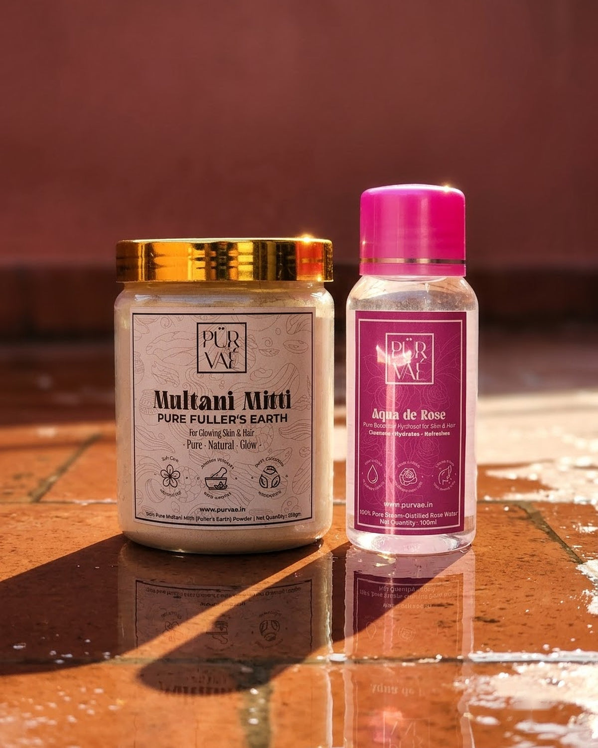 What's inside the Purvae Mitti Ritual: Multani mitti jar and rose water bottle on a tile