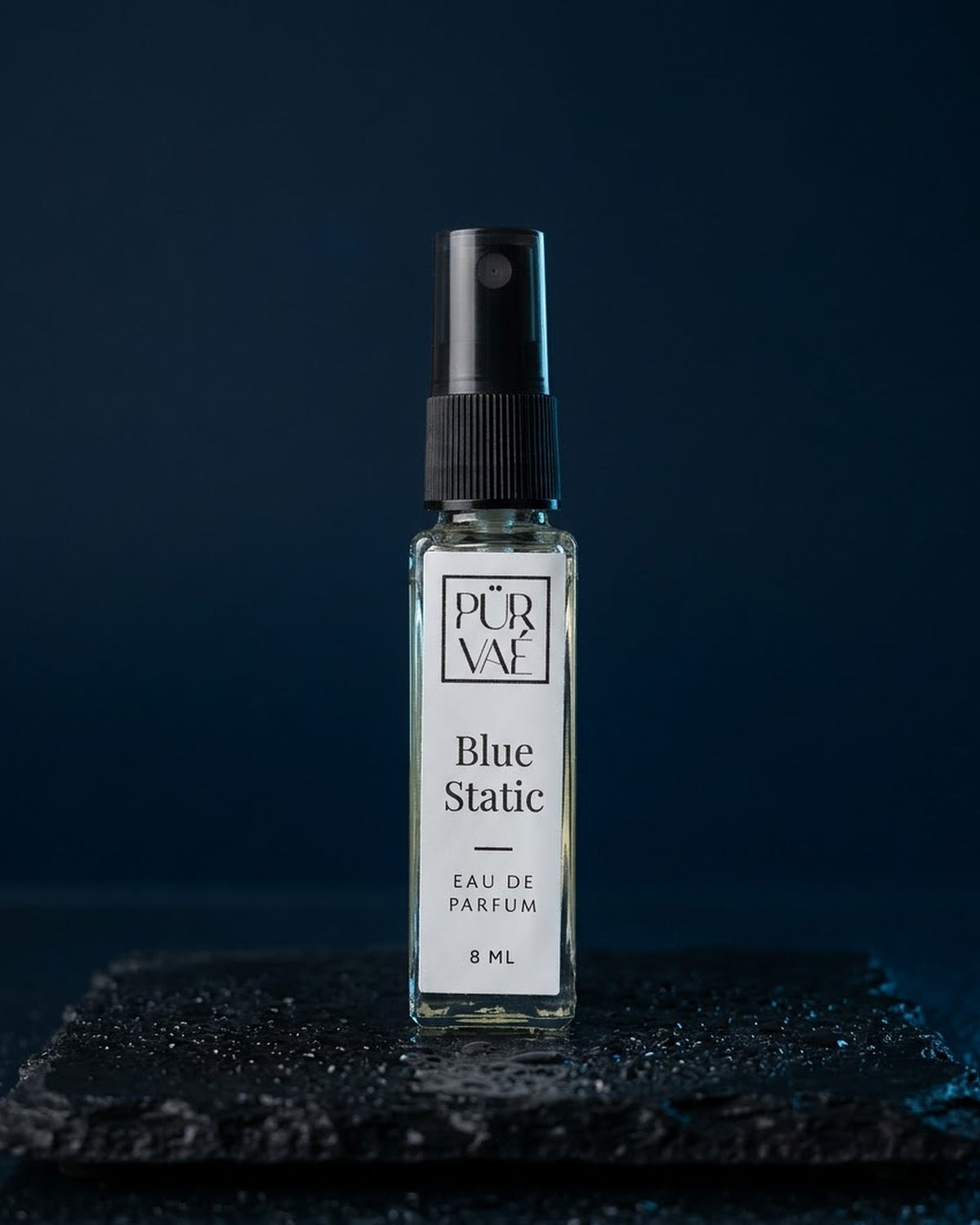 Blue Static eau de parfum 8 ml glass spray on wet slate in midnight blue light