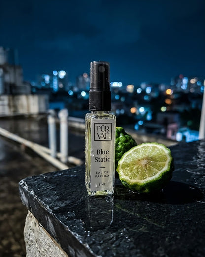 Blue Static on a wet rooftop ledge at night with a halved bergamot