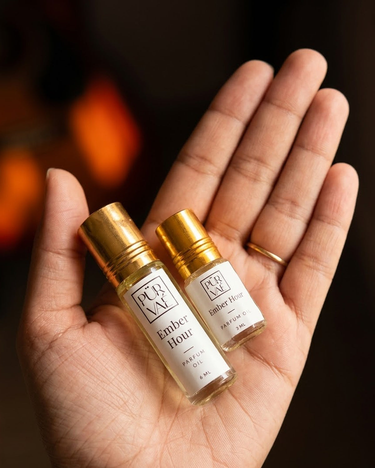Ember Hour parfum oil 6 ml and 3 ml held in one hand to show size