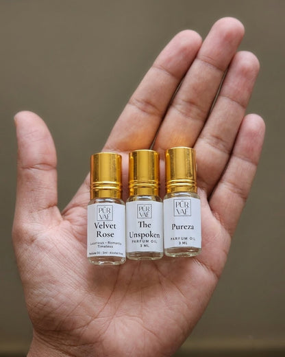 An open palm holding the three small 3 ml First Trio roll-ons to show their size