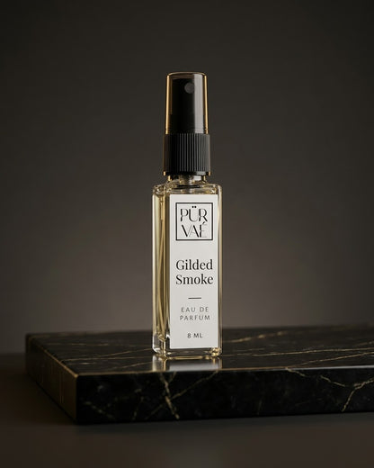 Gilded Smoke eau de parfum 8 ml glass spray on black and gold marble