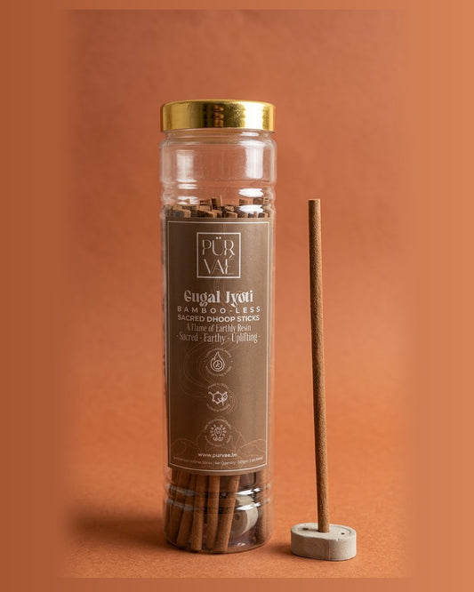 Purvae Gugal Jyoti bambooless dhoop sticks in a 200 g clear jar with a stick in its cement holder