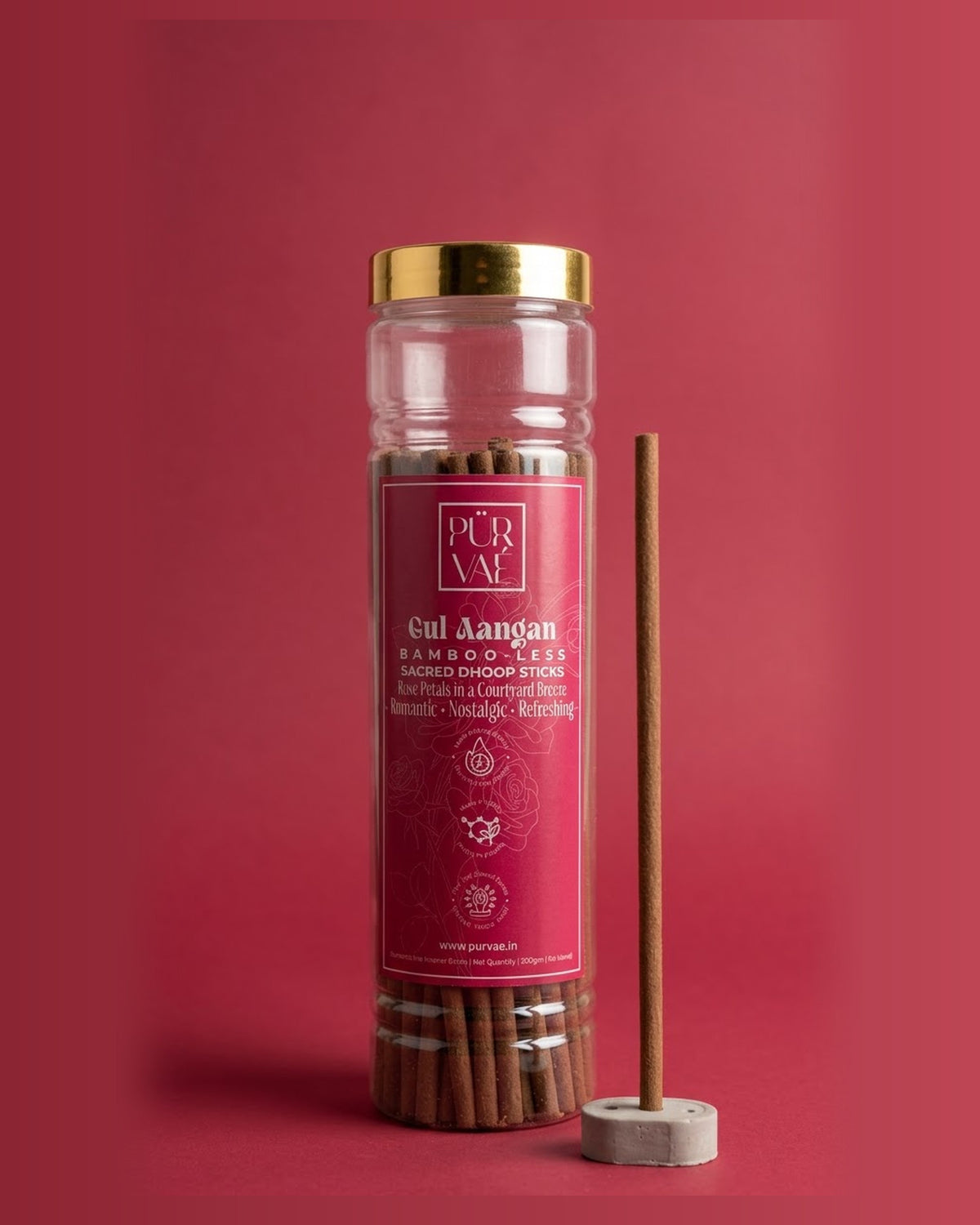 Purvae Gul Aangan bambooless dhoop sticks in a 200 g clear jar with a stick in its cement holder