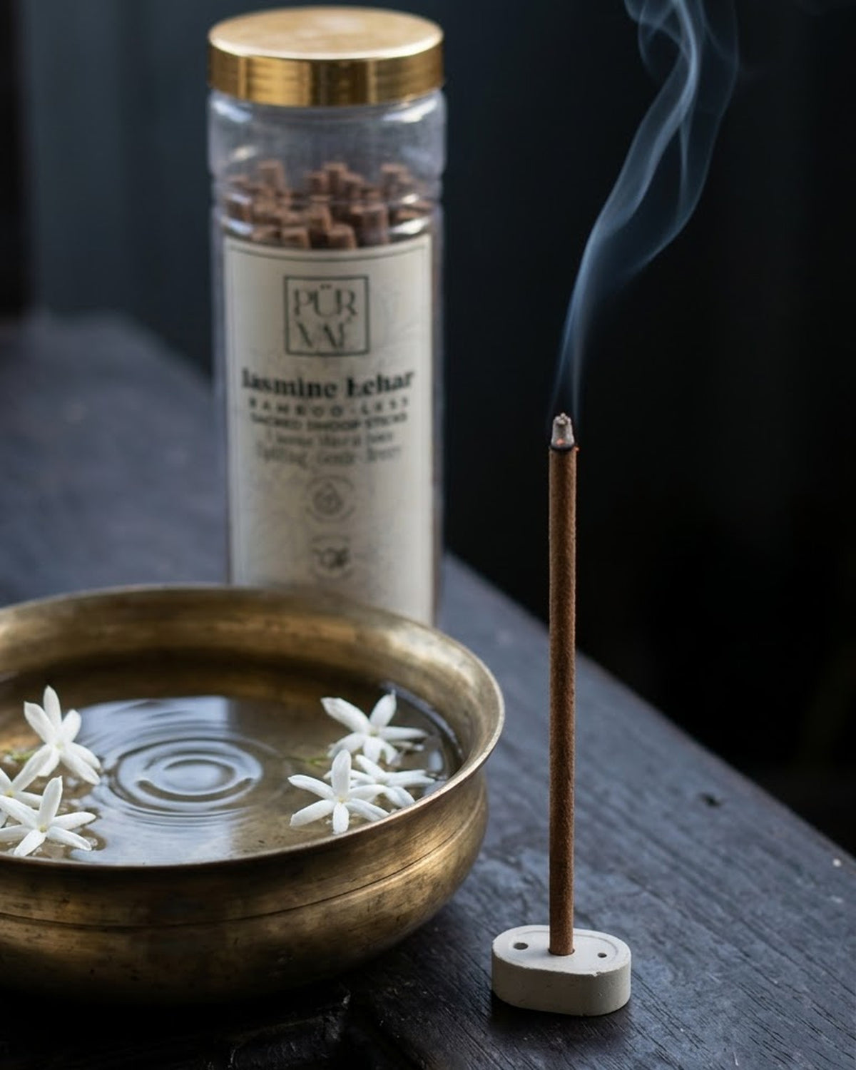 Jasmine Lehar dhoop stick burning beside a brass bowl of water with floating jasmine, Purvae jar behind