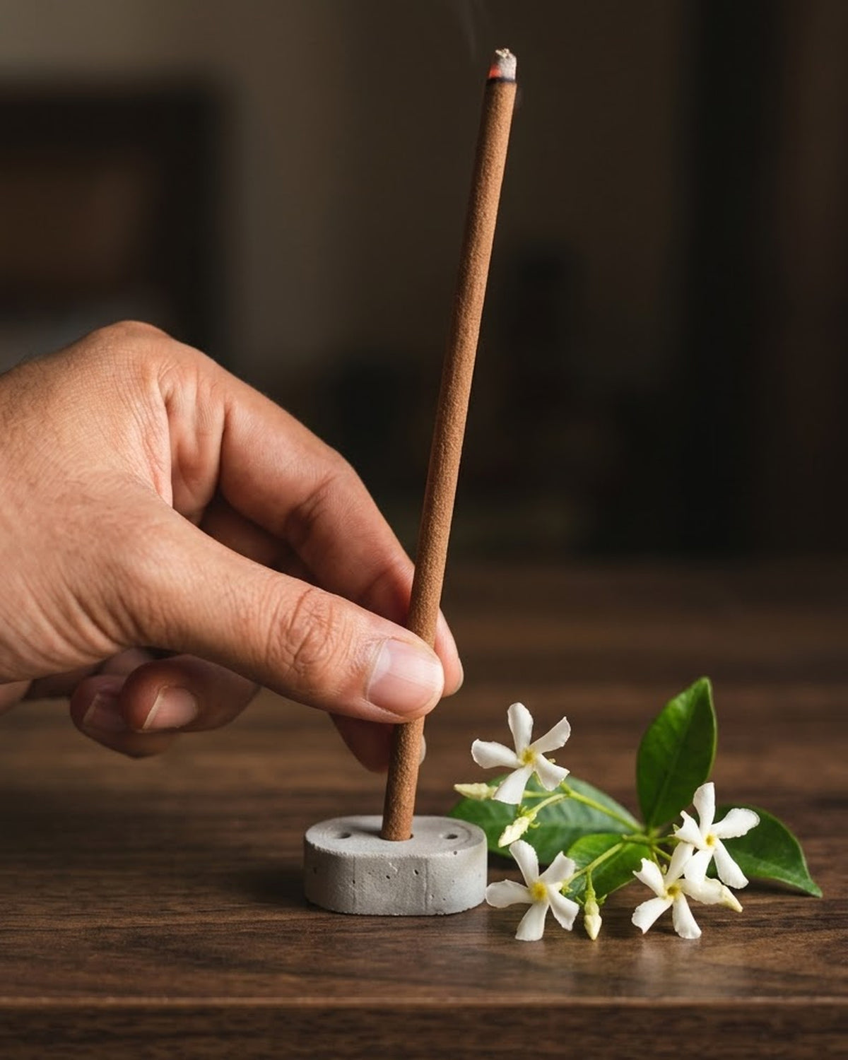Hand setting a 19 cm Jasmine Lehar dhoop stick into its cement holder to show true length