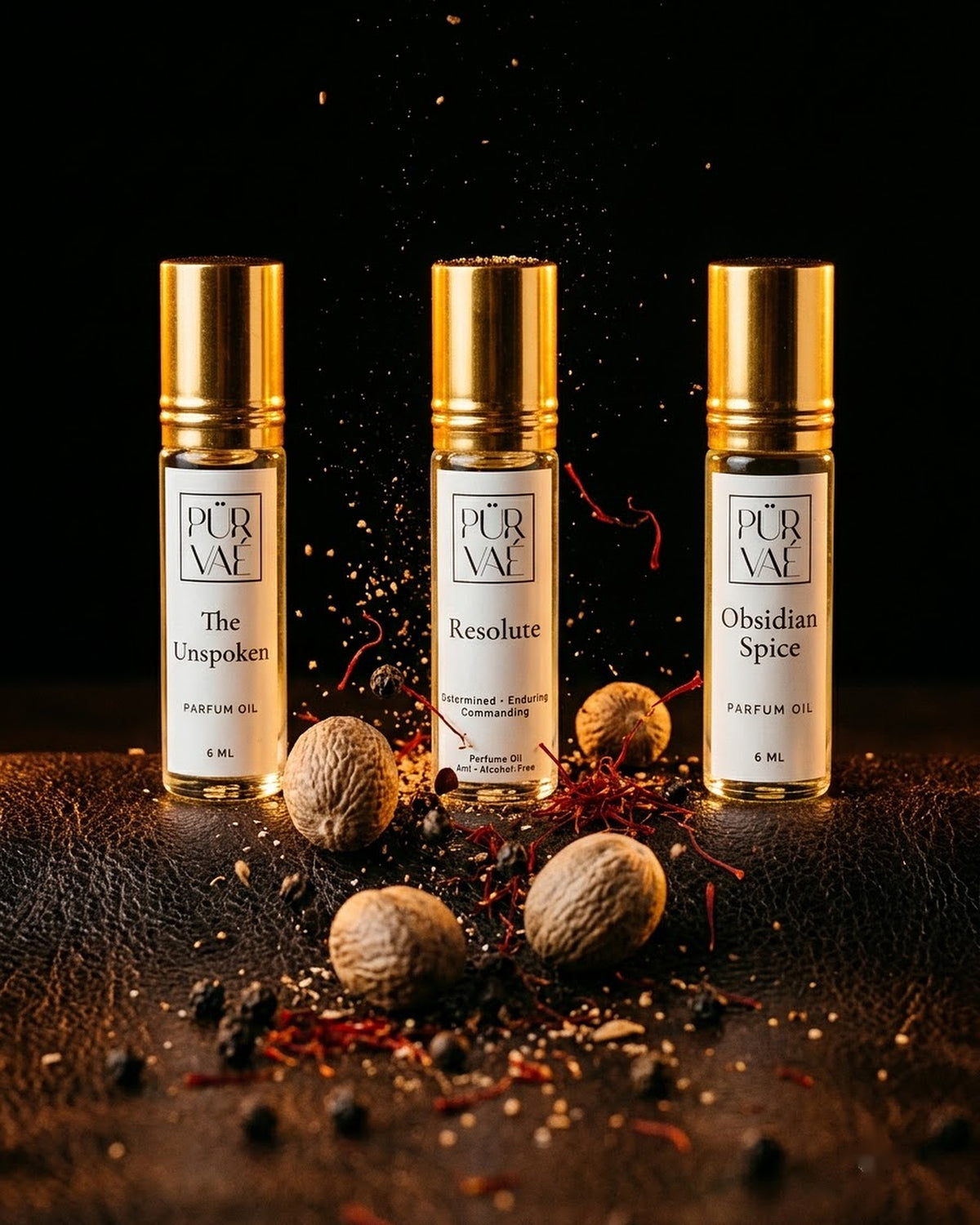 Three Purvae 6 ml parfum oils among tumbling nutmeg, saffron and black pepper on dark leather