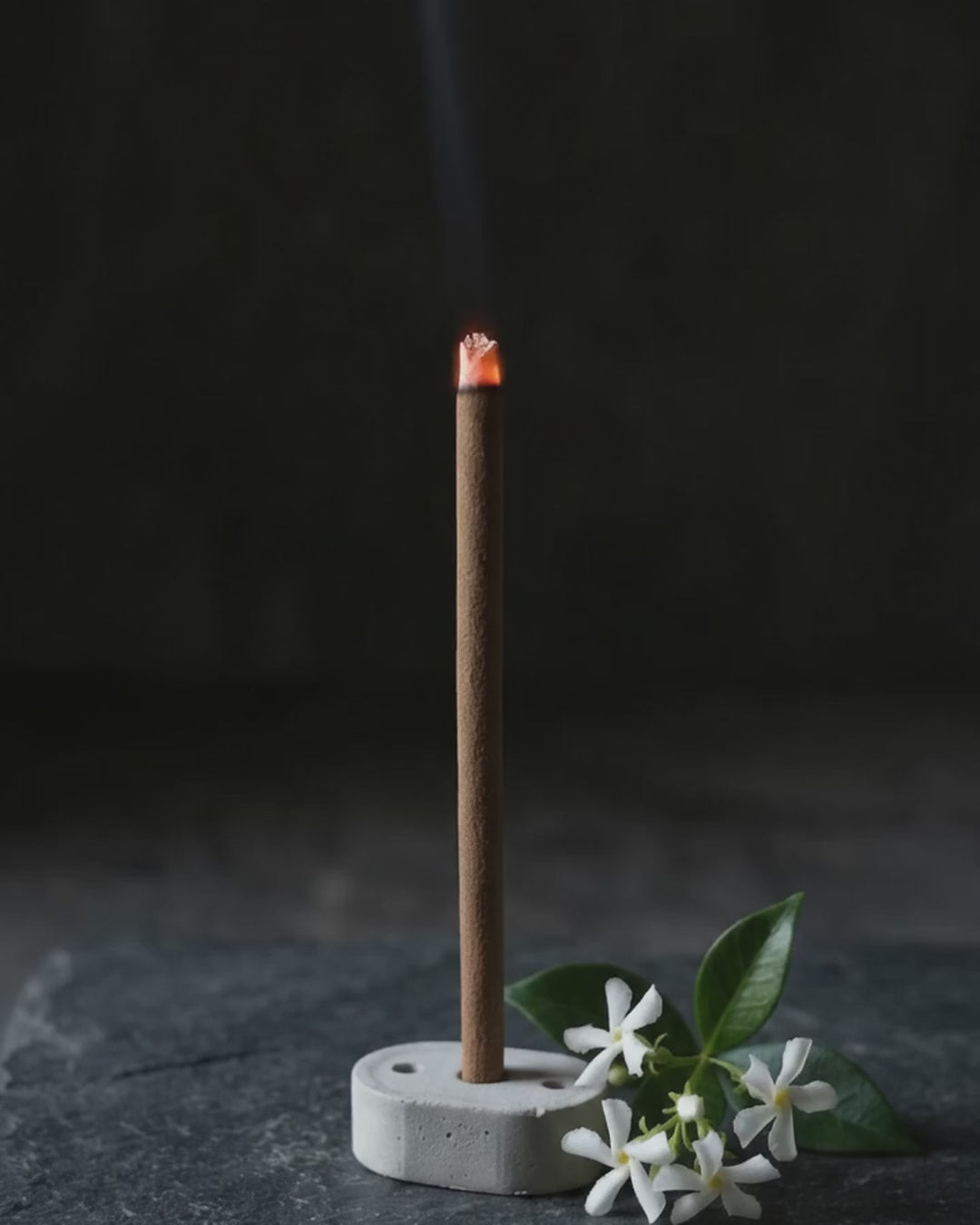 Smoke rising from a glowing Jasmine Lehar dhoop stick (6 second loop, no sound)