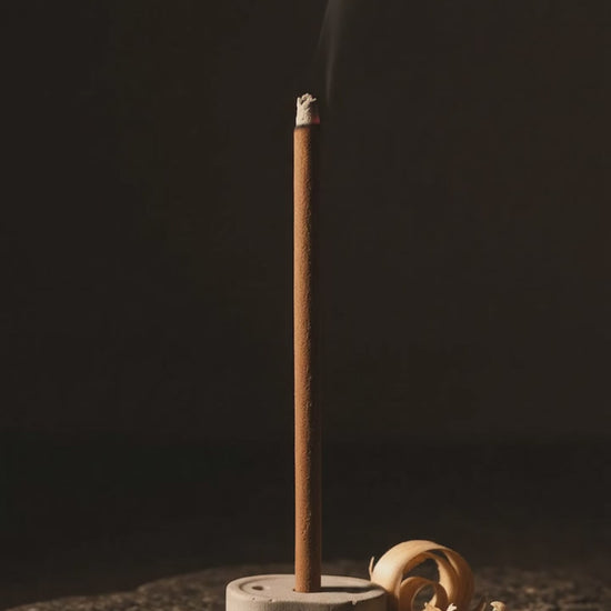 Smoke rising from a glowing Chandan Tattva dhoop stick (6 second loop, no sound)