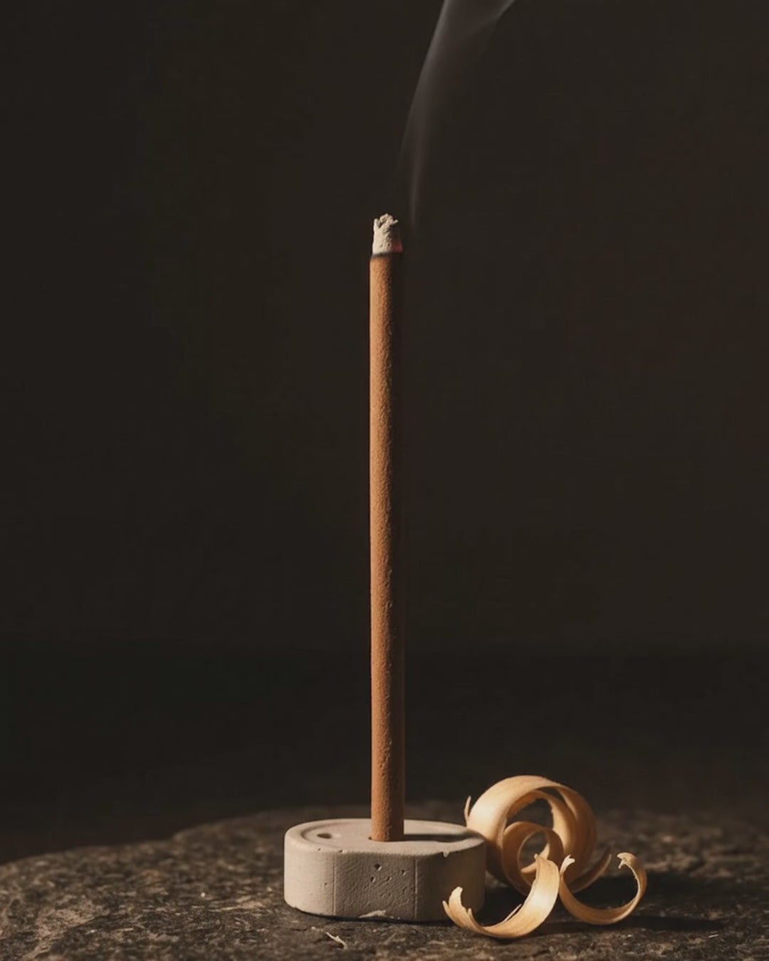 Smoke rising from a glowing Chandan Tattva dhoop stick (6 second loop, no sound)