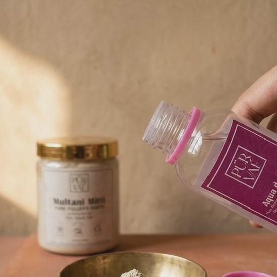 Rose water poured into Multani mitti powder