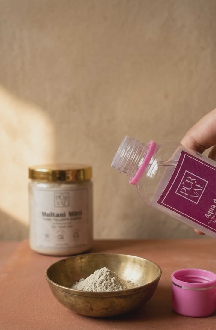 Rose water poured into Multani mitti powder