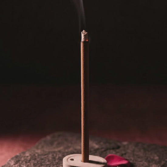 Smoke rising from a glowing Gul Aangan dhoop stick (6 second loop, no sound)