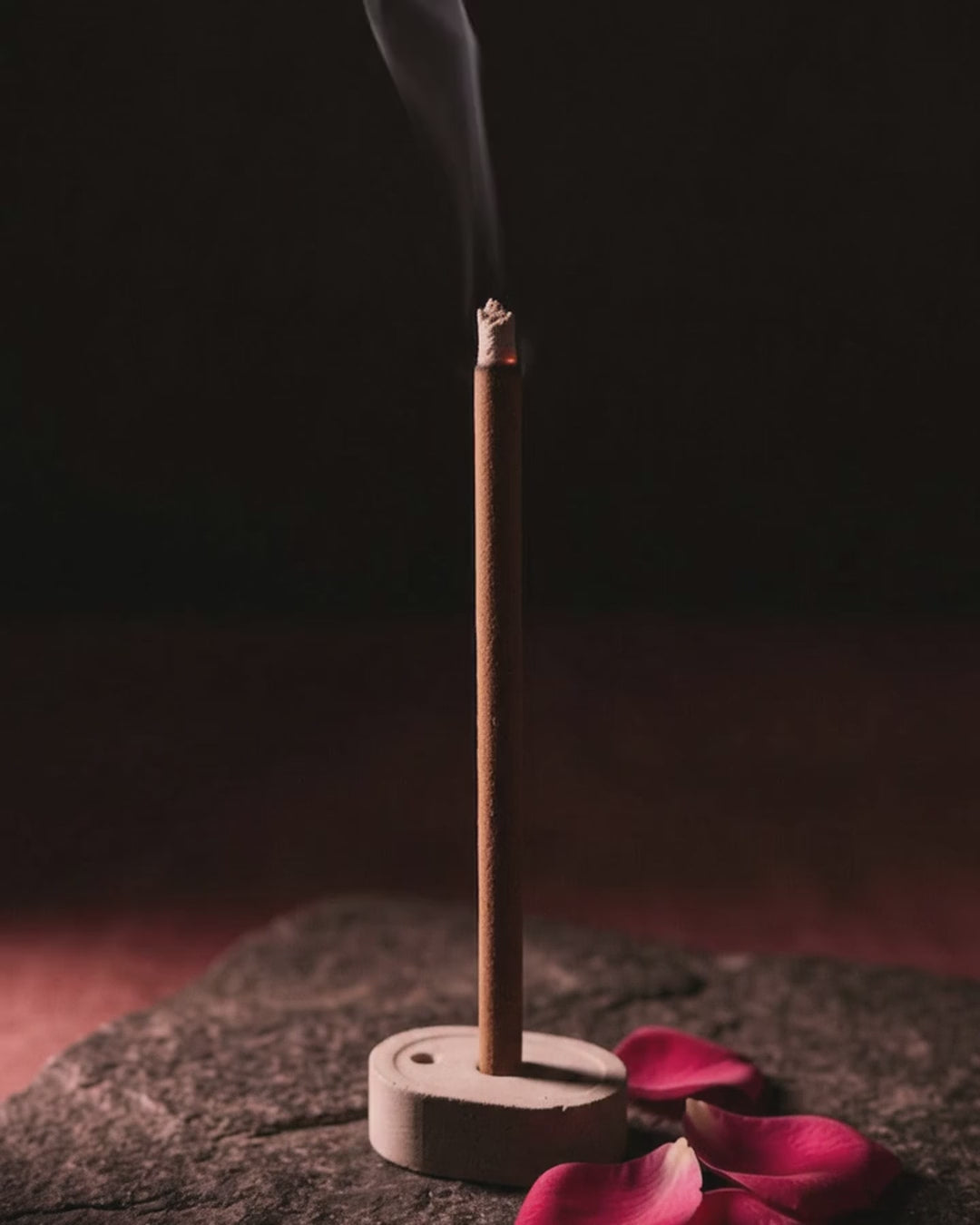 Smoke rising from a glowing Gul Aangan dhoop stick (6 second loop, no sound)