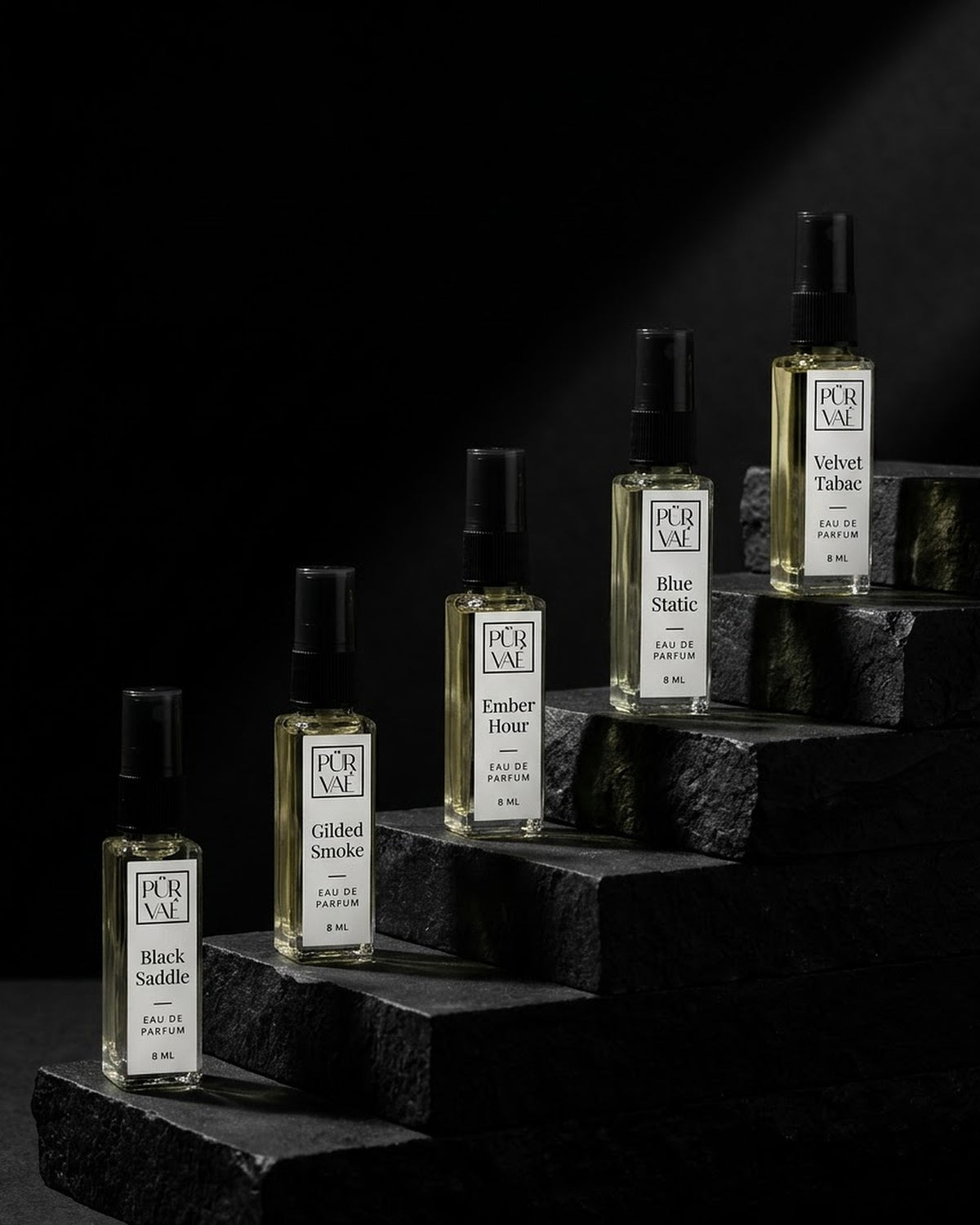 The five Root Five bottles on black stone steps