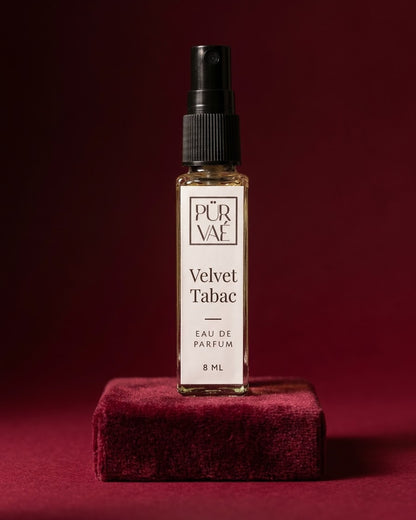 Velvet Tabac eau de parfum 8 ml glass spray on a burgundy velvet plinth