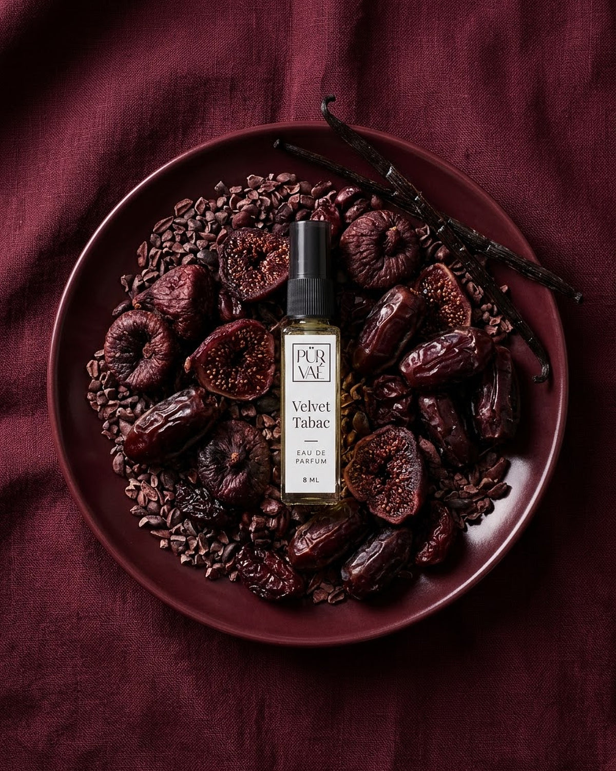 Velvet Tabac on a burgundy plate of dried figs, dates and cacao nibs